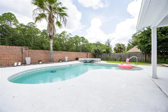 a view of a house with a backyard and a yard