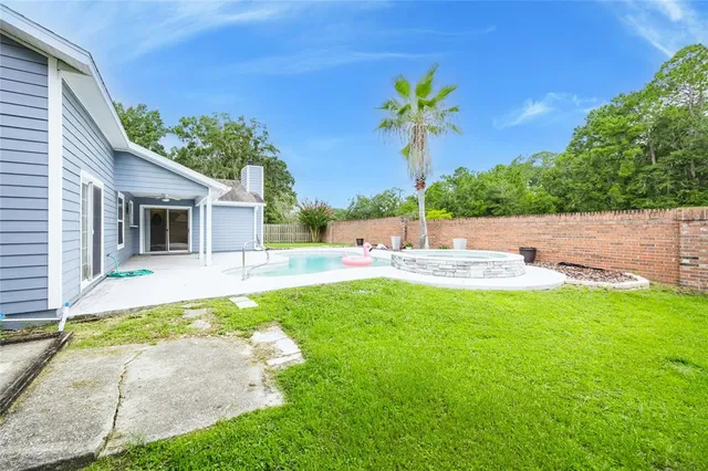 a view of a house with a yard and tree s