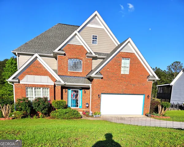 a front view of a house with a yard and garage