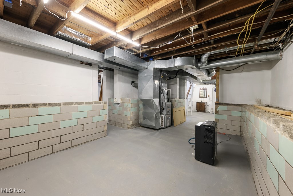 1702 Far View Road Akron, OH 44312 - Photo 32 of 49 Unfinished basement featuring heating unit