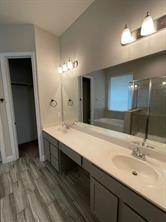 1913 Ridge Creek Lane Aubrey, TX 76227 - Photo 12 of 21 a bathroom with a double vanity sink and a mirror