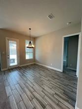 1913 Ridge Creek Lane Aubrey, TX 76227 - Photo 14 of 21 an empty room with wooden floor and windows