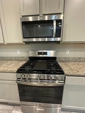 1913 Ridge Creek Lane Aubrey, TX 76227 - Photo 16 of 21 a stove top oven sitting inside of a kitchen