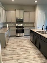 1913 Ridge Creek Lane Aubrey, TX 76227 - Photo 3 of 21 a kitchen with stainless steel appliances granite countertop a sink stove and cabinets