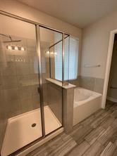 1913 Ridge Creek Lane Aubrey, TX 76227 - Photo 6 of 21 a bathroom with a bathtub and a shower