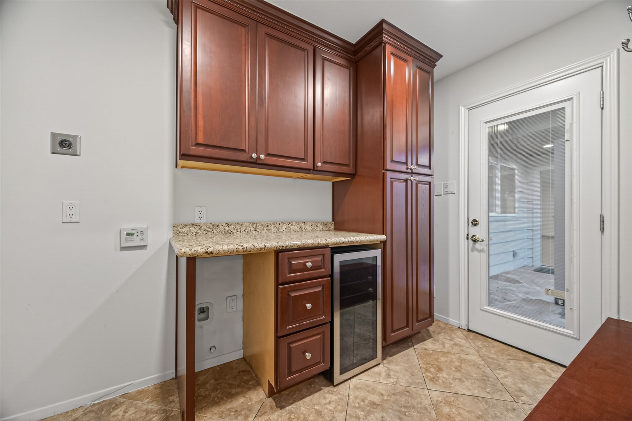 5638 Sanford Road Houston, TX 77096 - Photo 16 of 41 *additional wine fridge has been installed*
Utility room with dry bar and mudroom functionality. Additional Washer/dryer connections located in the garage, offering the flexibility to expand the kitchen into this space if desired.