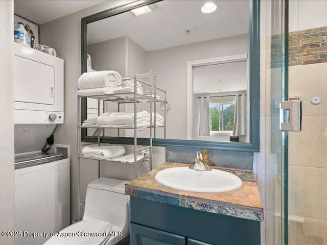 a bathroom with a sink toilet and shower