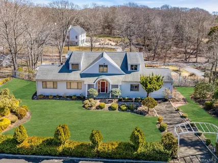an aerial view of a house with garden space ocean view