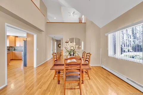 a view of a dining room with furniture a chandelier and wooden floor
