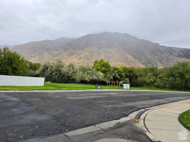 1025 North 300 West, Unit 1 Springville, UT 84663 - Photo 34 of 35 View of asphalt road featuring a mountain view, curbs, view of wooded area, and sidewalks