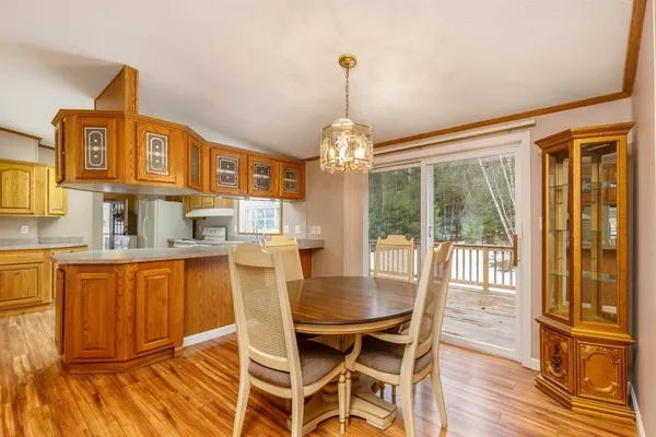a view of a dining room with furniture wooden floor and chandelier