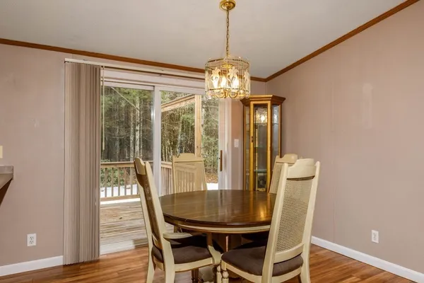 a view of a dining room with furniture wooden floor and chandelier