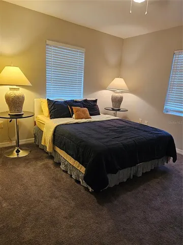 a bedroom with two beds and painting on the wall