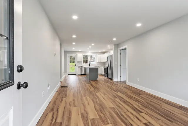 a view of a living room with wooden floor
