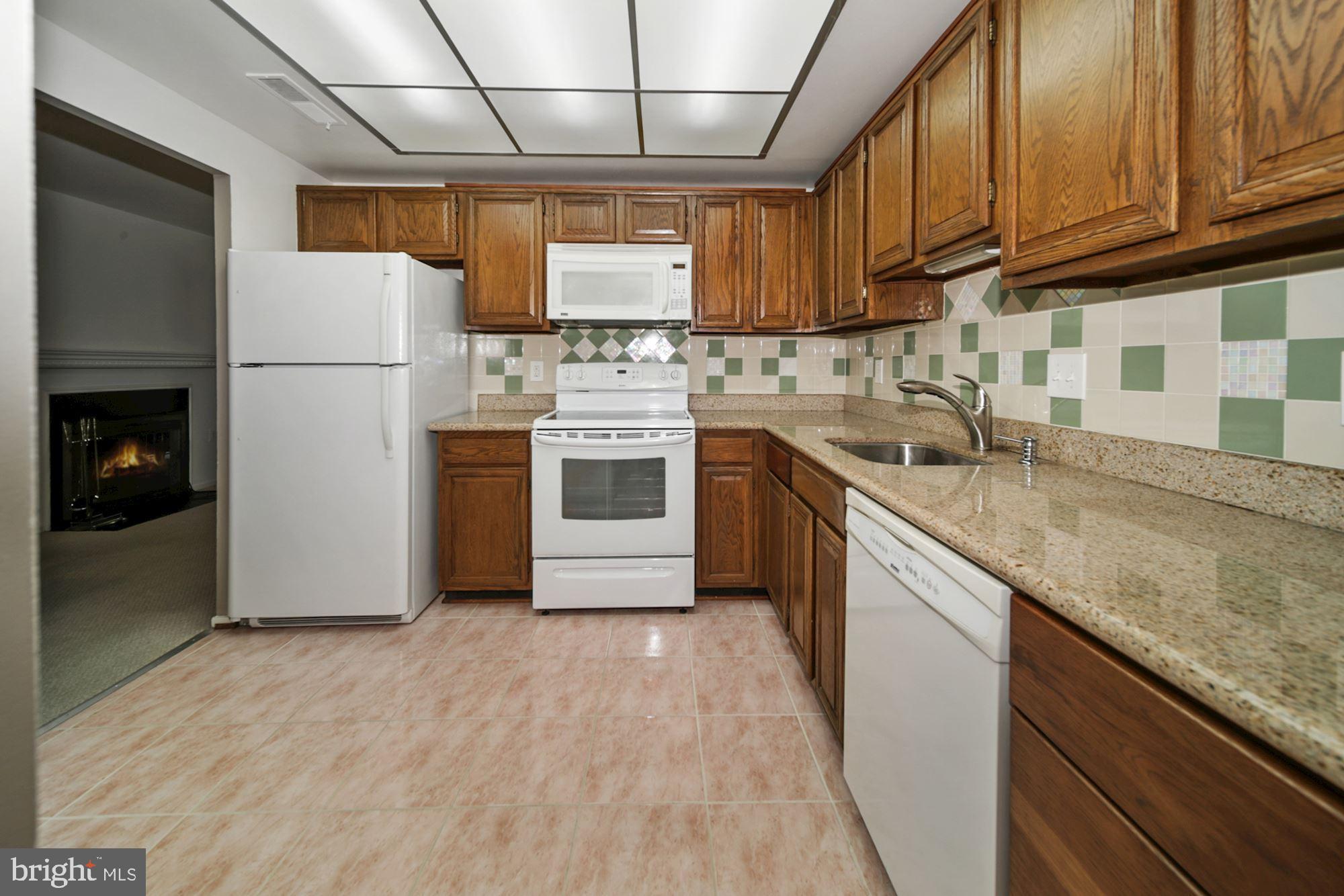 10026 Stedwick Road, Unit 204 Gaithersburg, MD 20886 - Photo 3 of 37 BRIGHT & OPEN KITCHEN w/ granite countertops
