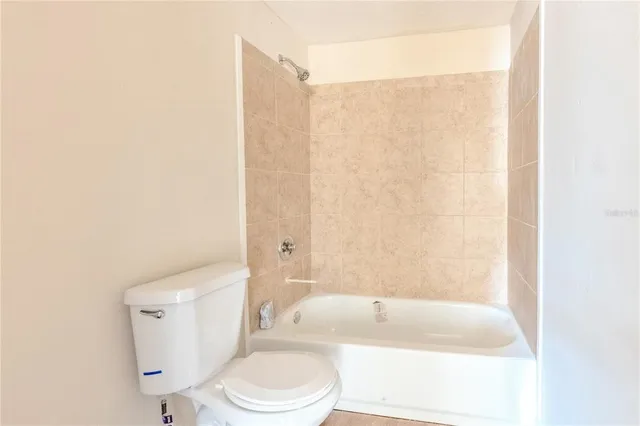 a bathroom with a toilet and a bathtub