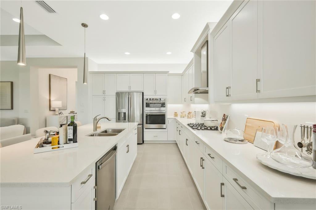 11805 Drake Lane Naples, FL 34120 - Photo 11 of 30 a large kitchen with kitchen island a sink appliances and cabinets