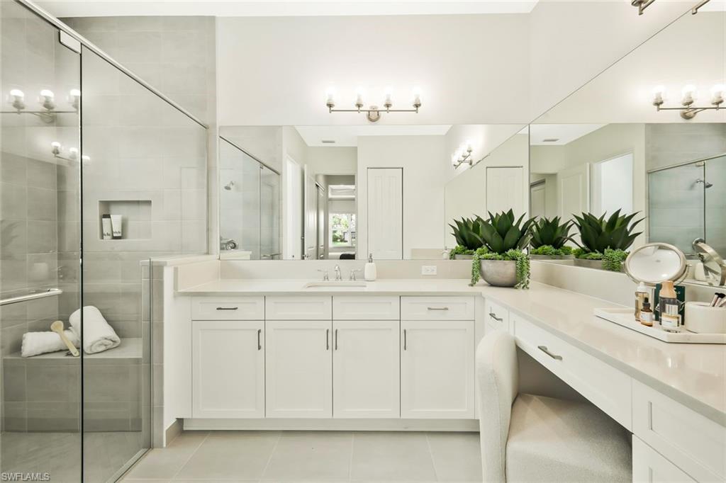 11805 Drake Lane Naples, FL 34120 - Photo 18 of 30 a bathroom with a sink vanity and a mirror