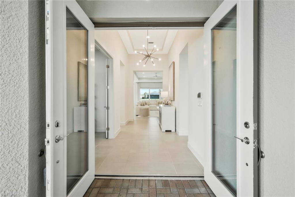 11805 Drake Lane Naples, FL 34120 - Photo 3 of 30 wooden floor in a gallery with a chandelier