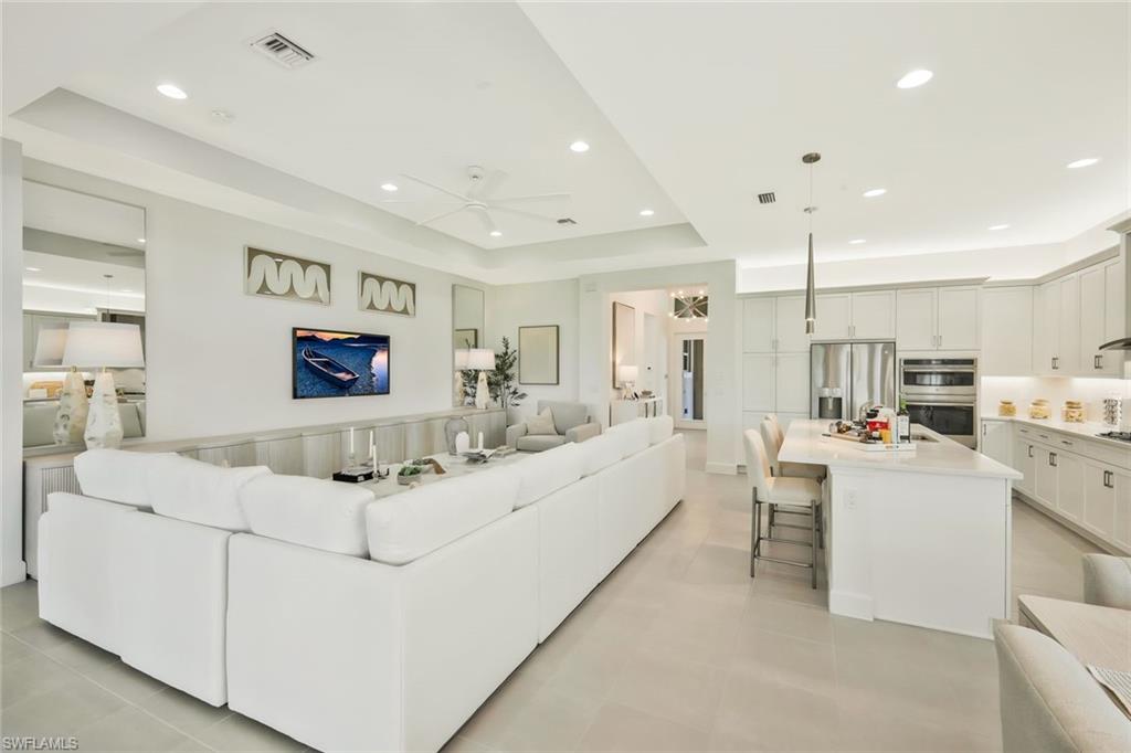 11805 Drake Lane Naples, FL 34120 - Photo 4 of 30 a living room with furniture and a flat screen tv