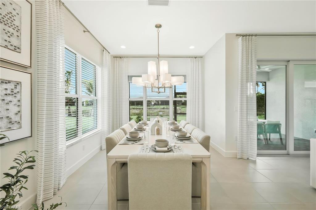 11805 Drake Lane Naples, FL 34120 - Photo 7 of 30 a view of a dining room with furniture wooden floor and a chandelier