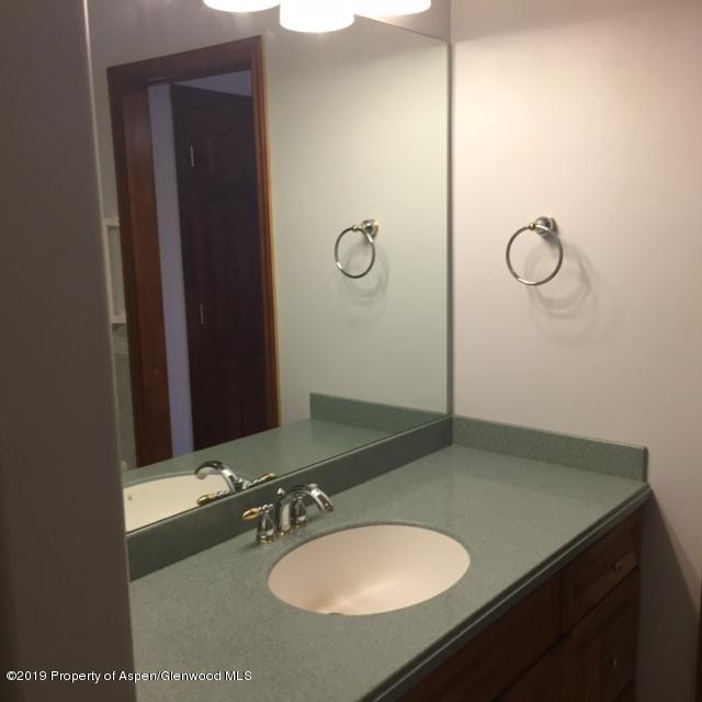 1453 Fir Court Rifle, CO 81650 - Photo 17 of 28 a bathroom with a sink vanity and a mirror