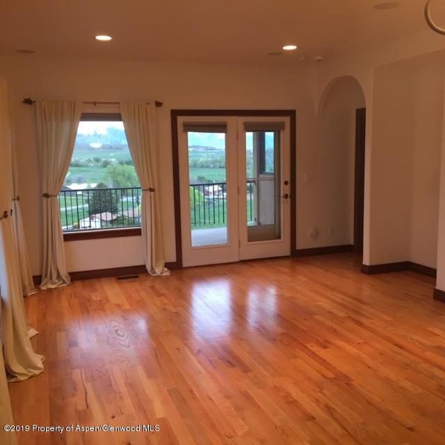 1453 Fir Court Rifle, CO 81650 - Photo 7 of 28 an empty room with wooden floor and windows