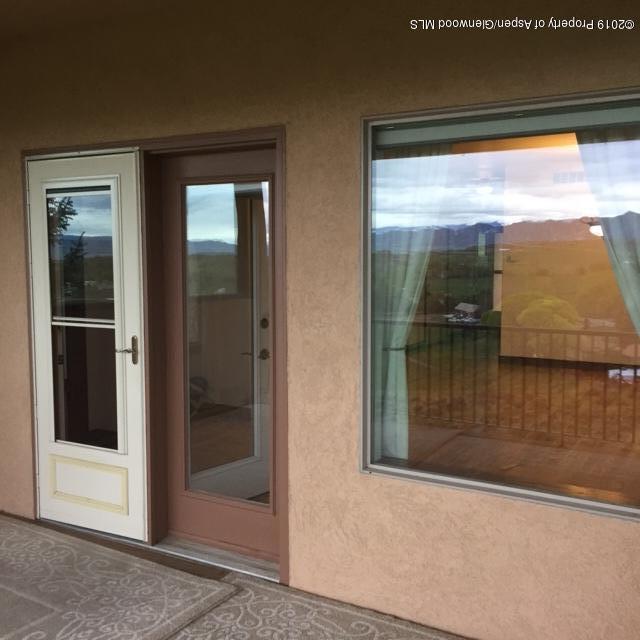 1453 Fir Court Rifle, CO 81650 - Photo 9 of 28 a view of backyard from a hall with a glass door