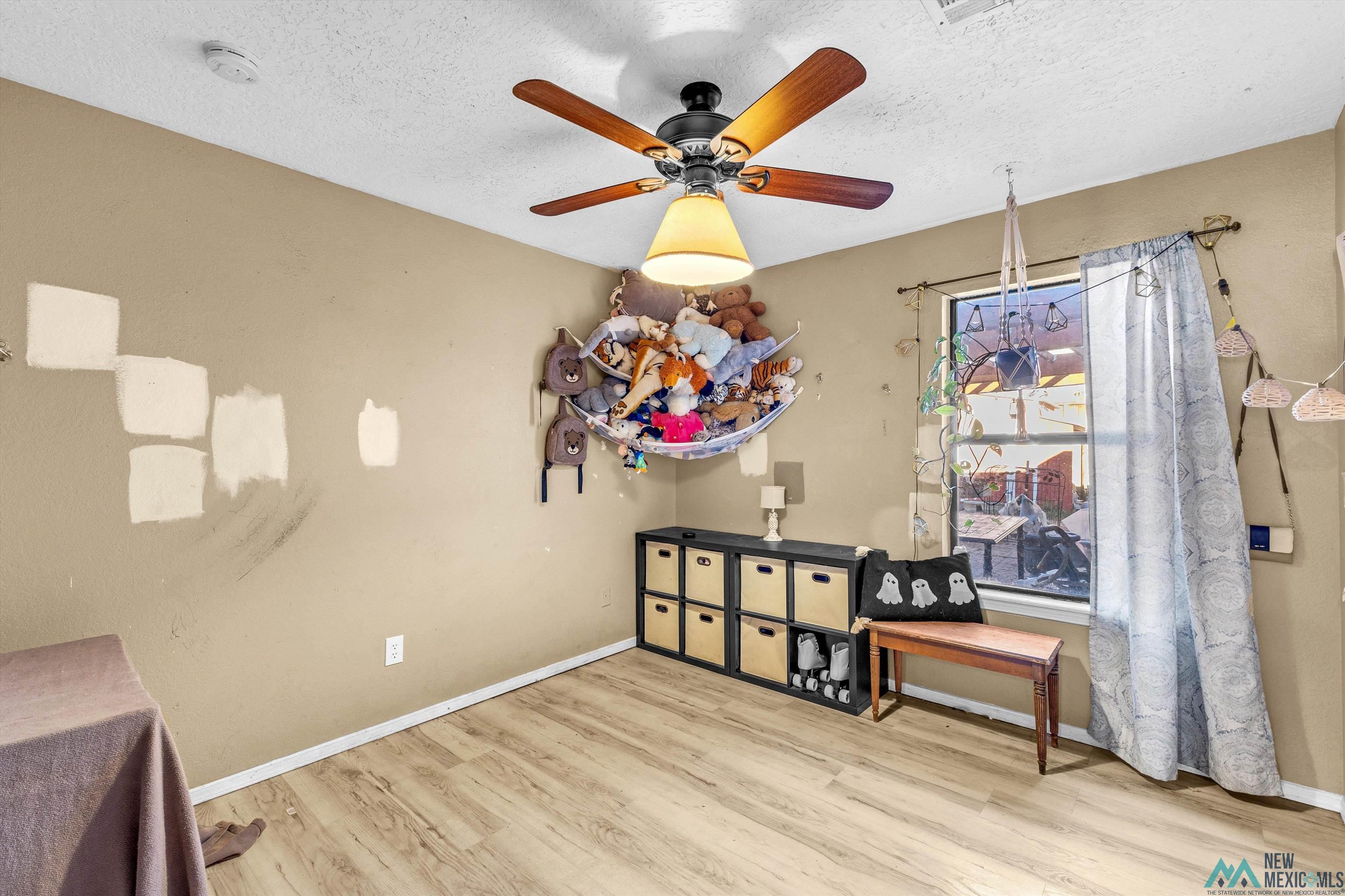 5008 Shadow Road Las Cruces, NM 88011 - Photo 10 of 35 Dining area featuring a textured ceiling, a ceiling fan, and wood finished floors