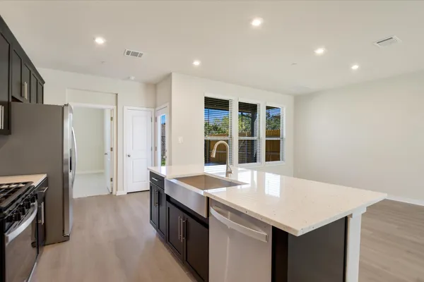 a kitchen with granite countertop a stove and a refrigerator