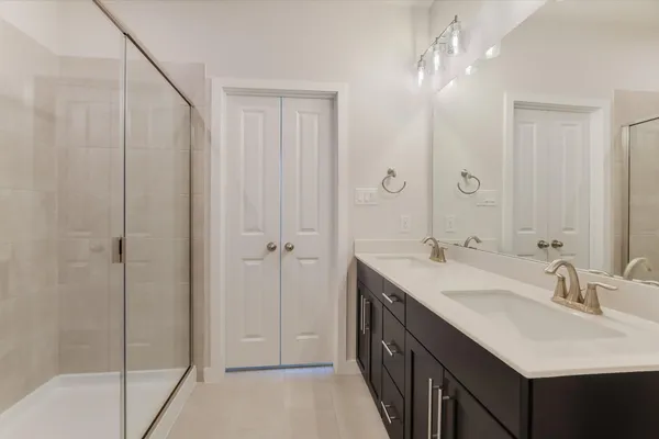 a bathroom with 2 sink and a mirror