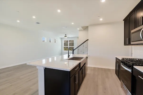 a kitchen with a sink appliances and cabinets