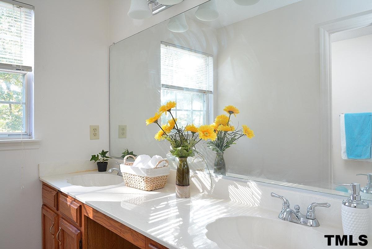 604 Carpenter Fletcher Road Durham, NC 27713 - Photo 18 of 24 Dual cultured marble vanities with an operable window in the master bathroom. Separate vanity and toilet/shower area.