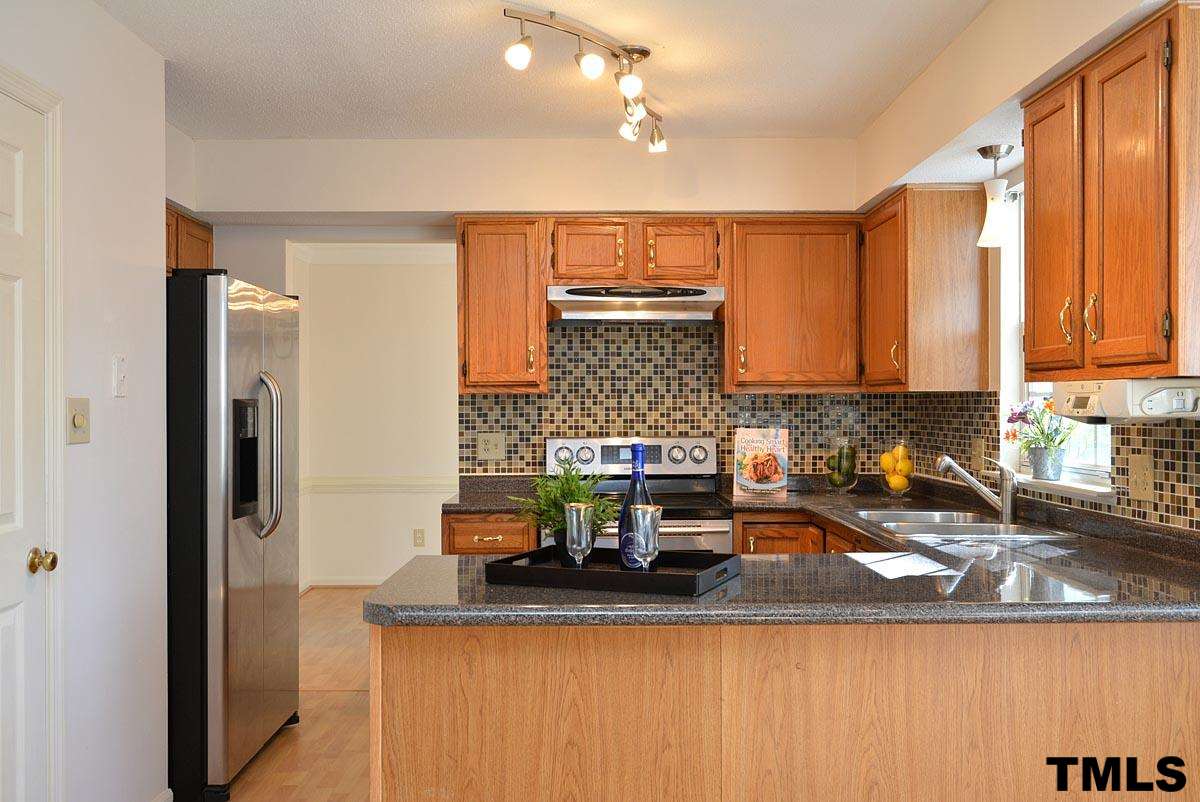 Island peninsula in the kitchen overlooking the breakfast nook. Stainless steel fridge!