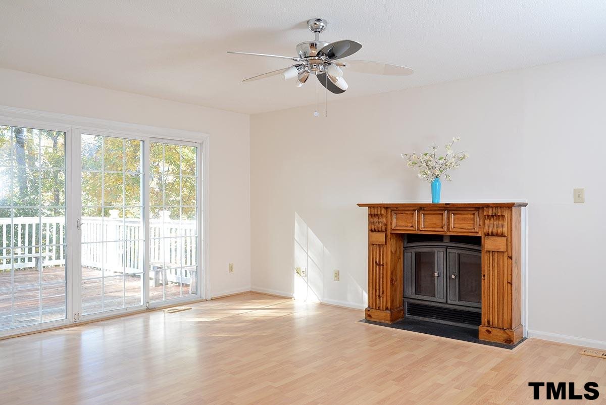 604 Carpenter Fletcher Road Durham, NC 27713 - Photo 10 of 24 Spacious family room with a custom designed mantle fireplace and gleaming laminate hardwood floors! Access to deck!