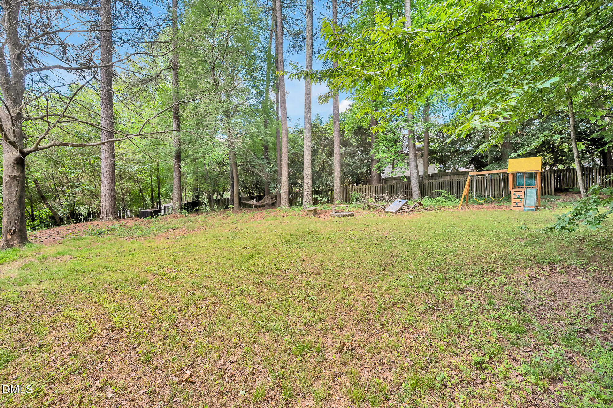7500 Drayton Court Raleigh, NC 27615 - Photo 25 of 27 a backyard of a house with lots of green space and fountain