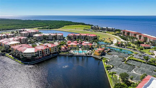 an aerial view of a houses with an outdoor space and seating area