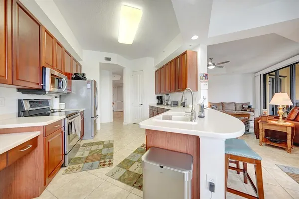a large kitchen with stainless steel appliances granite countertop a sink and cabinets