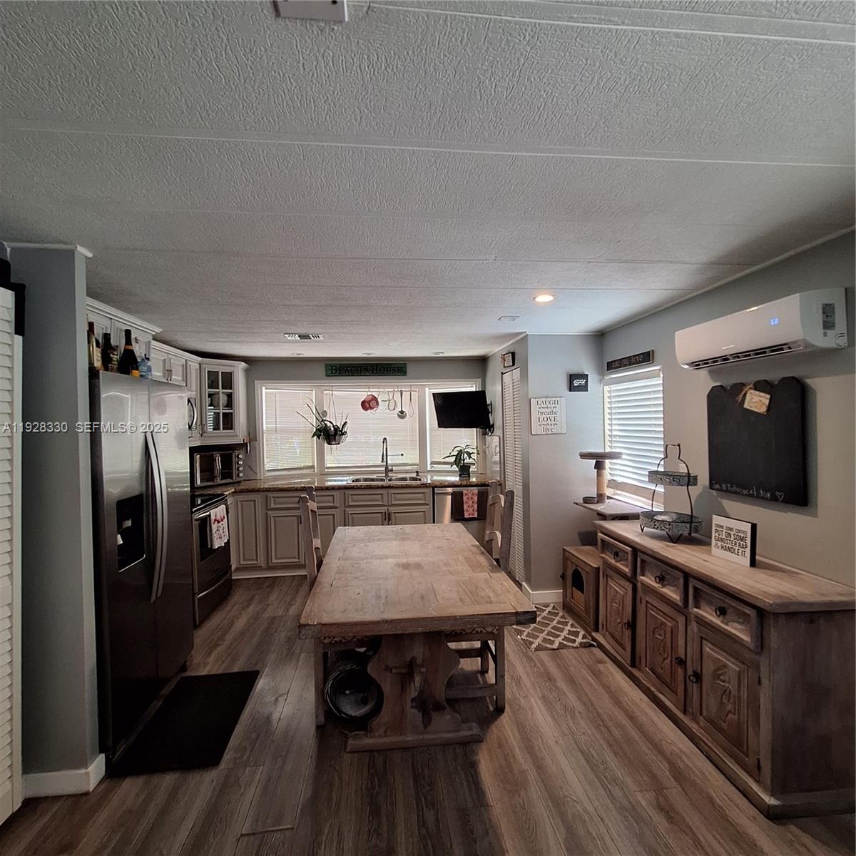 256 Lee Avenue Key Largo, FL 33037 - Photo 5 of 11 a kitchen with stainless steel appliances a table chairs and a refrigerator
