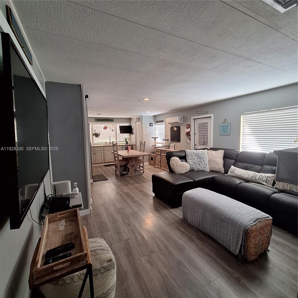 256 Lee Avenue Key Largo, FL 33037 - Photo 8 of 11 a living room with furniture wooden floor and a flat screen tv