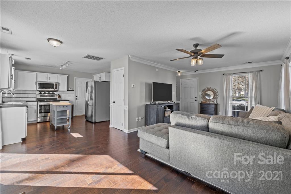 4010 Suttle Place Matthews, NC 28104 - Photo 11 of 31 a living room with furniture and a wooden floor