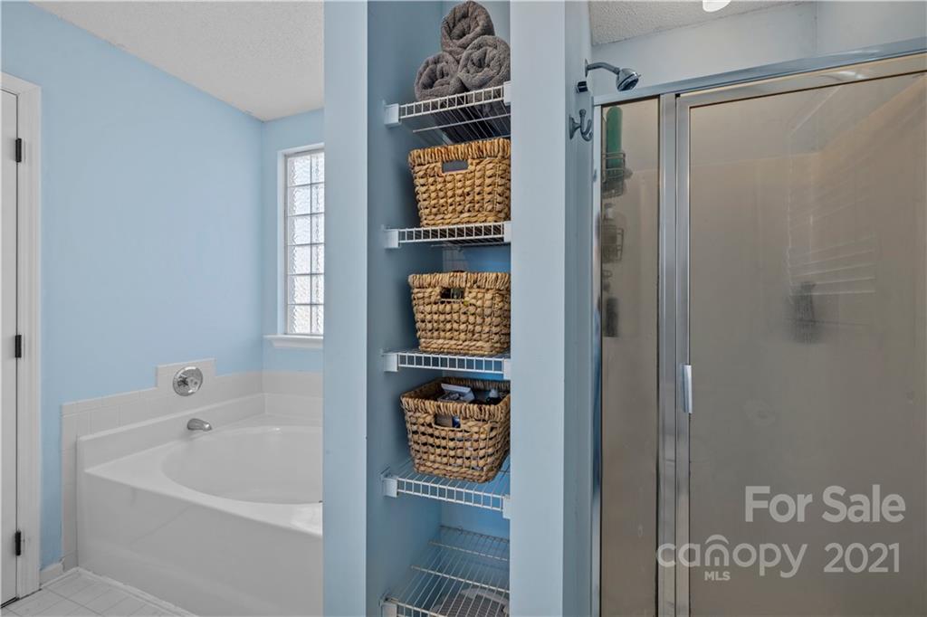 4010 Suttle Place Matthews, NC 28104 - Photo 21 of 31 a bathroom with a bathtub and a shower