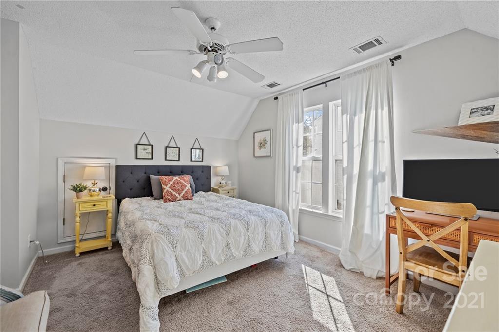 4010 Suttle Place Matthews, NC 28104 - Photo 22 of 31 a bedroom with a bed and a chandelier