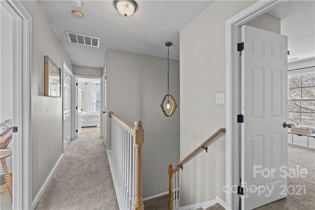 4010 Suttle Place Matthews, NC 28104 - Photo 26 of 31 a view of a hallway with wooden floor and staircase