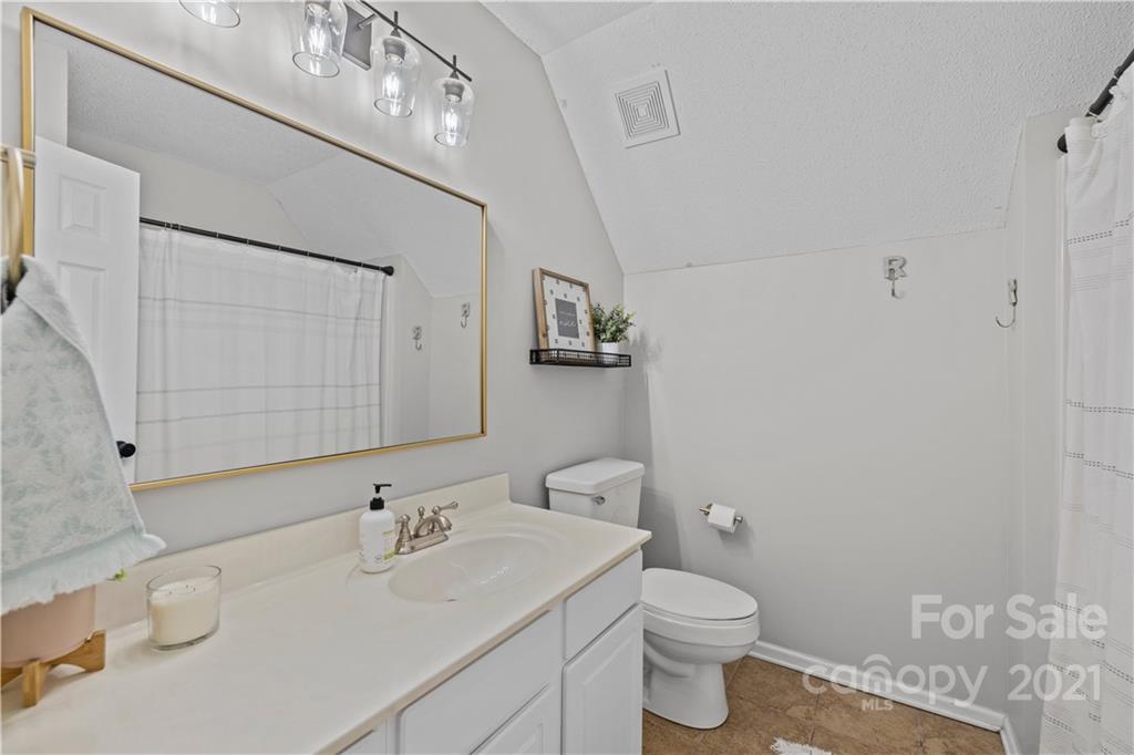 4010 Suttle Place Matthews, NC 28104 - Photo 27 of 31 a bathroom with a sink a toilet and mirror
