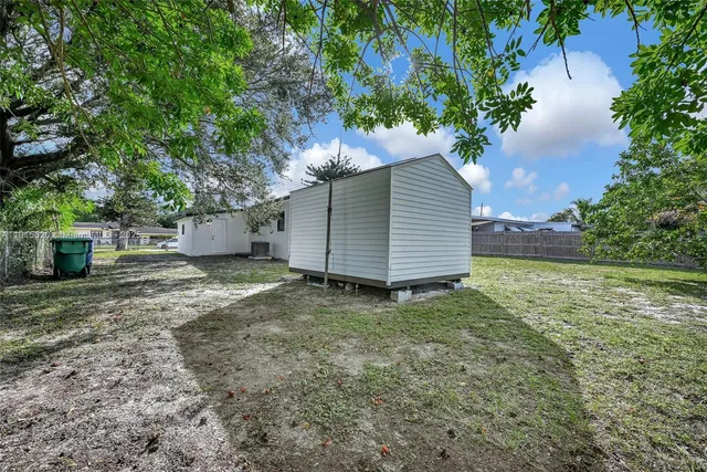 a view of a house with a yard and garage