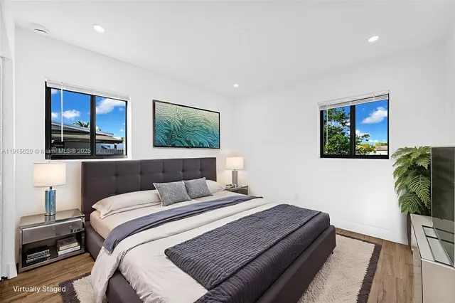 a view of a big room with wooden floor and windows
