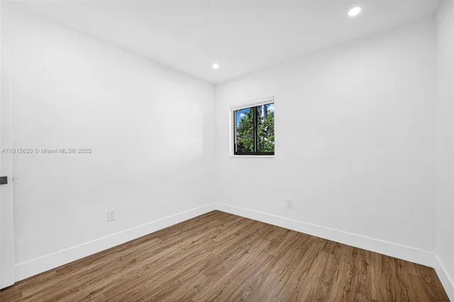 a bedroom with a bed and painting on the wall