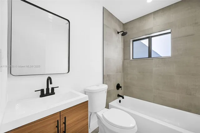 a bathroom with a toilet a sink and bathtub