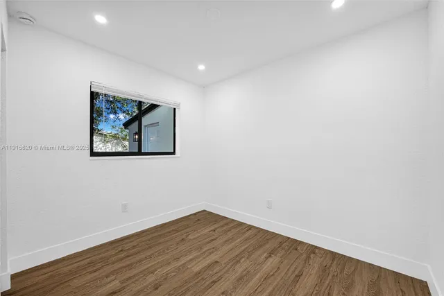 a view of a workspace with furniture and a bookshelf